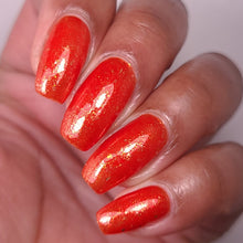 nail polish by crystal knockout, carnelian meld, red orange jelly with gold flakes and shimmer