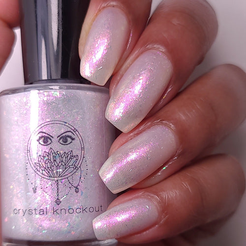 nail polish by crystal knockout, angel aura shock, sheer white with pink glow and iridescent flakes