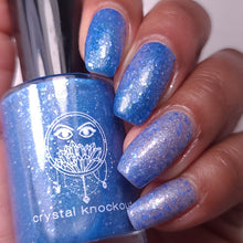 nail polish by crystal knockout, aventurine hit, a dark blue to light blue thermal with matte blue and white glitter